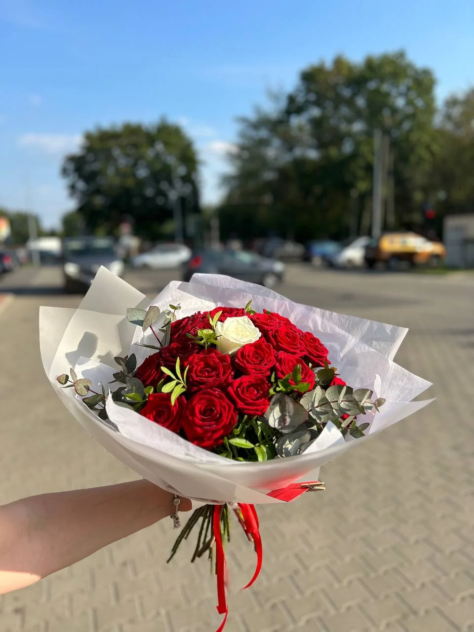 Efektowny bukiet czerwonych róż z dodatkiem eukaliptusa i białej róży